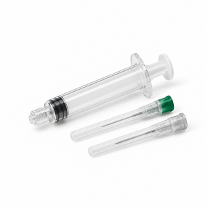 Generic clear preparation syringe beside two capped preparation needles on a white background.